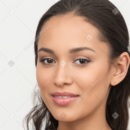 Joyful latino young-adult female with long  brown hair and brown eyes