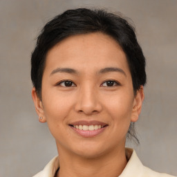 Joyful asian young-adult female with short  brown hair and brown eyes