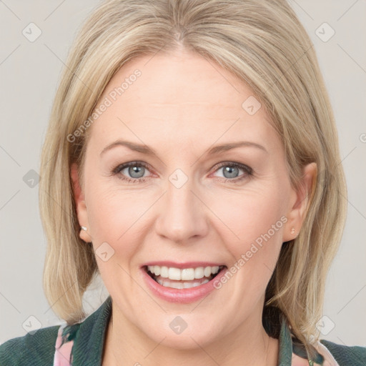 Joyful white adult female with medium  brown hair and blue eyes