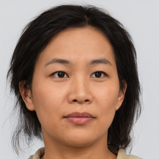 Joyful asian young-adult female with medium  brown hair and brown eyes