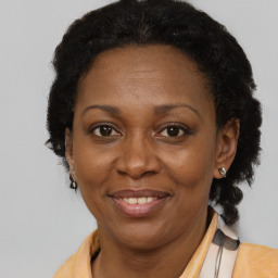 Joyful black adult female with short  brown hair and brown eyes
