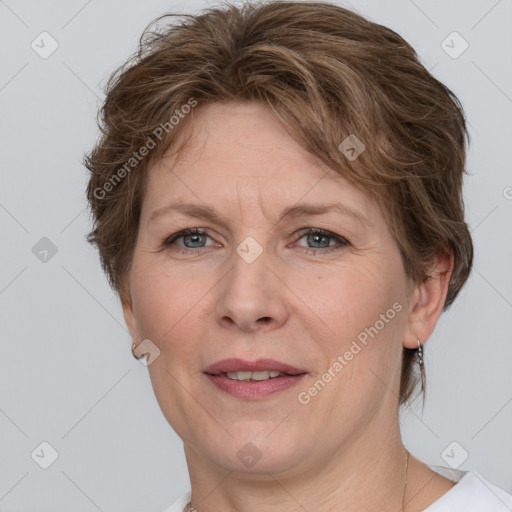 Joyful white adult female with medium  brown hair and grey eyes