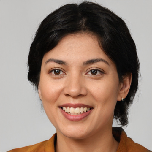 Joyful asian young-adult female with medium  brown hair and brown eyes
