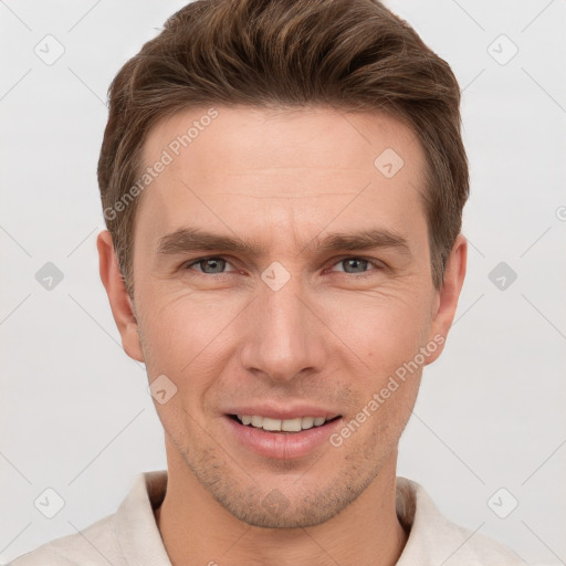 Joyful white young-adult male with short  brown hair and grey eyes