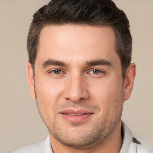 Joyful white young-adult male with short  brown hair and brown eyes