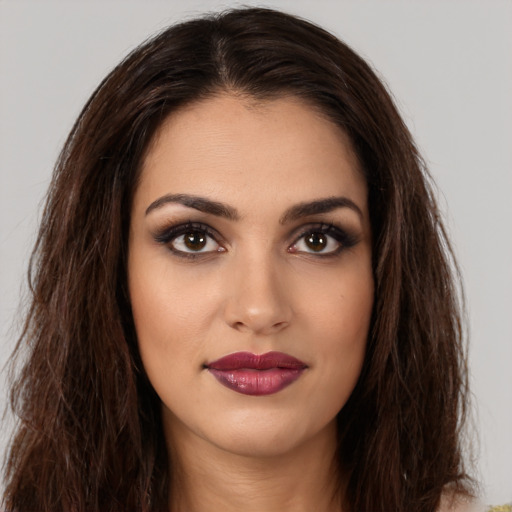 Joyful white young-adult female with long  brown hair and brown eyes