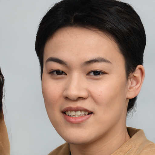 Joyful asian young-adult female with short  black hair and brown eyes