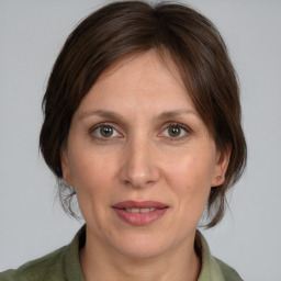 Joyful white adult female with medium  brown hair and brown eyes