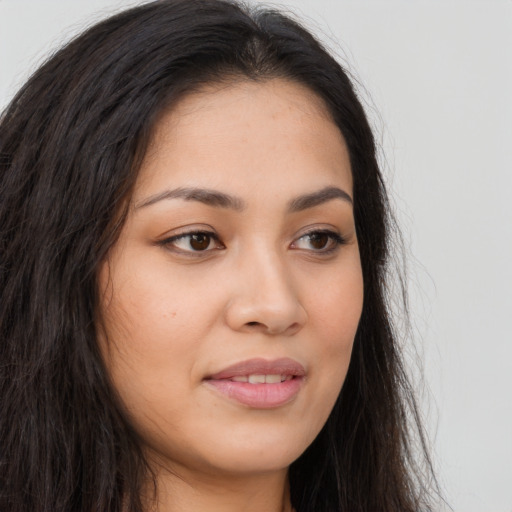 Joyful latino young-adult female with long  brown hair and brown eyes