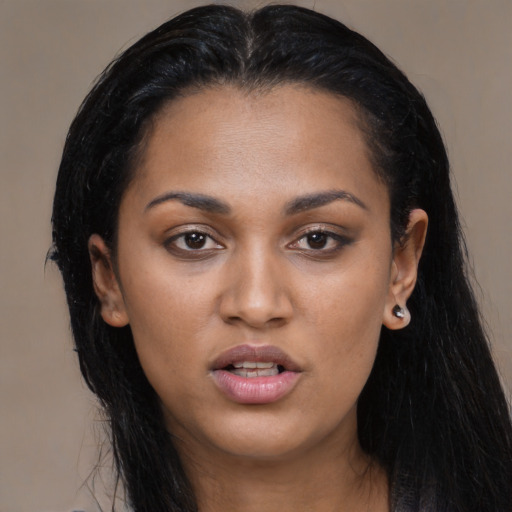 Joyful latino young-adult female with long  black hair and brown eyes