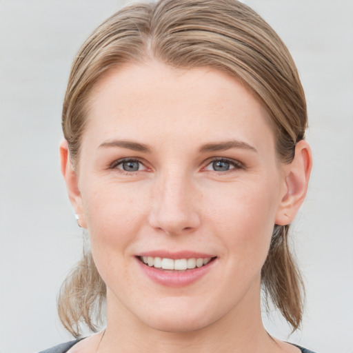 Joyful white young-adult female with medium  brown hair and blue eyes