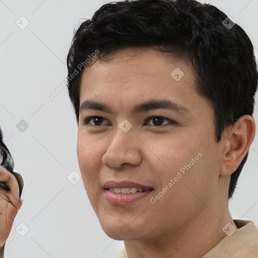 Joyful latino young-adult male with short  black hair and brown eyes