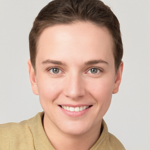 Joyful white young-adult female with short  brown hair and grey eyes