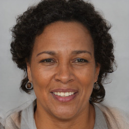 Joyful black adult female with short  brown hair and brown eyes