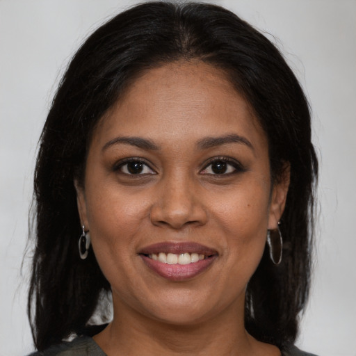 Joyful black young-adult female with medium  brown hair and brown eyes