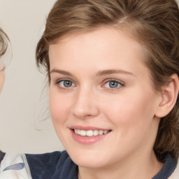 Joyful white young-adult female with medium  brown hair and blue eyes