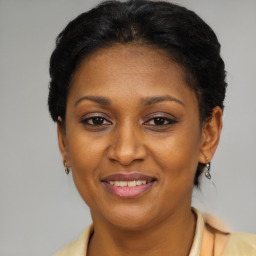 Joyful black adult female with short  brown hair and brown eyes