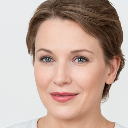 Joyful white young-adult female with medium  brown hair and grey eyes