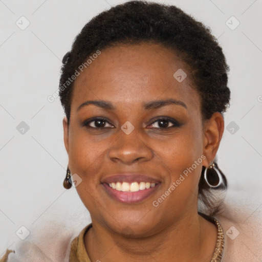 Joyful black young-adult female with short  brown hair and brown eyes