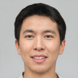 Joyful asian young-adult male with short  brown hair and brown eyes