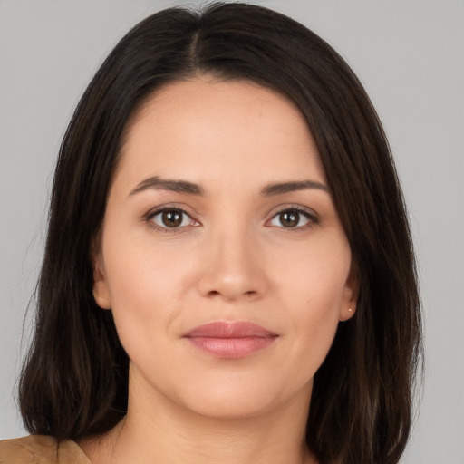 Joyful white young-adult female with long  brown hair and brown eyes