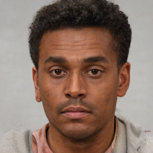 Neutral latino adult male with short  brown hair and brown eyes