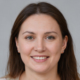 Joyful white adult female with long  brown hair and brown eyes