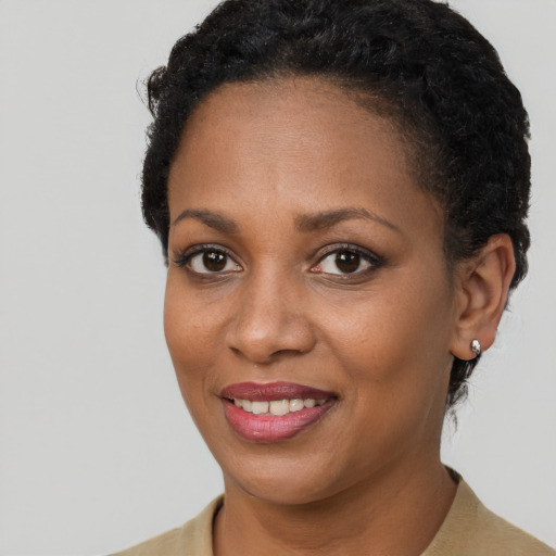 Joyful black young-adult female with short  brown hair and brown eyes
