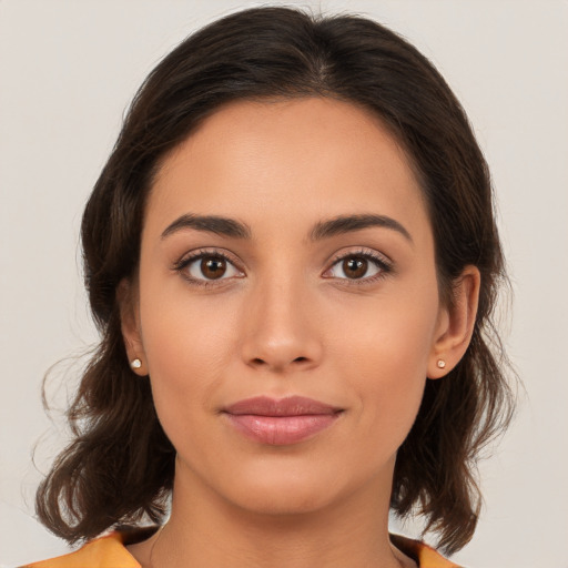 Joyful white young-adult female with medium  brown hair and brown eyes