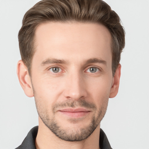 Joyful white young-adult male with short  brown hair and grey eyes