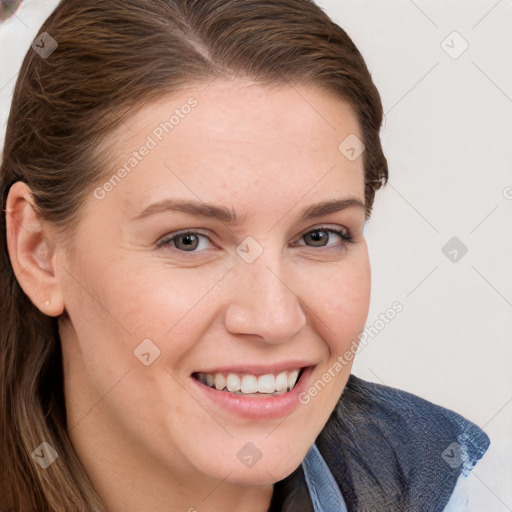 Joyful white young-adult female with long  brown hair and blue eyes