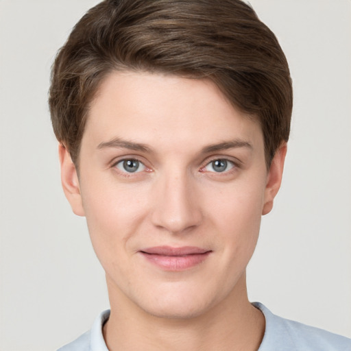 Joyful white young-adult female with short  brown hair and grey eyes