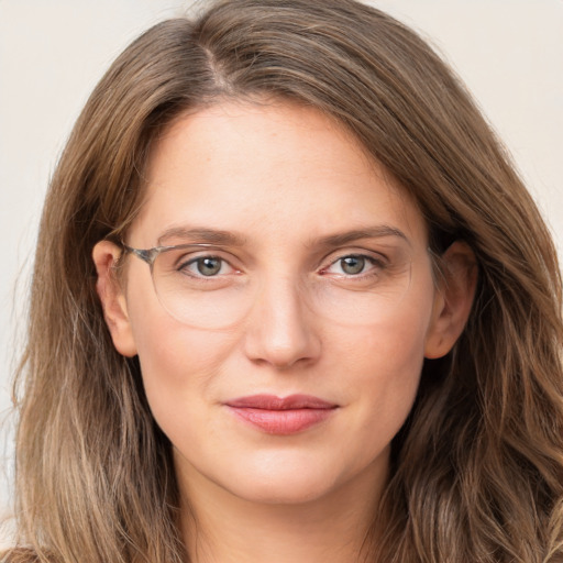 Joyful white young-adult female with long  brown hair and green eyes