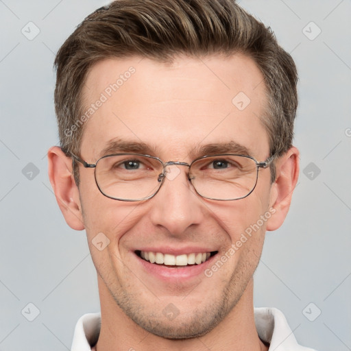 Joyful white adult male with short  brown hair and grey eyes