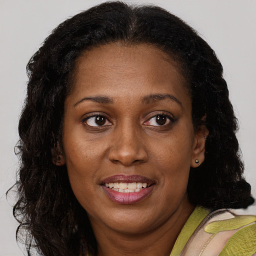 Joyful black young-adult female with medium  brown hair and brown eyes