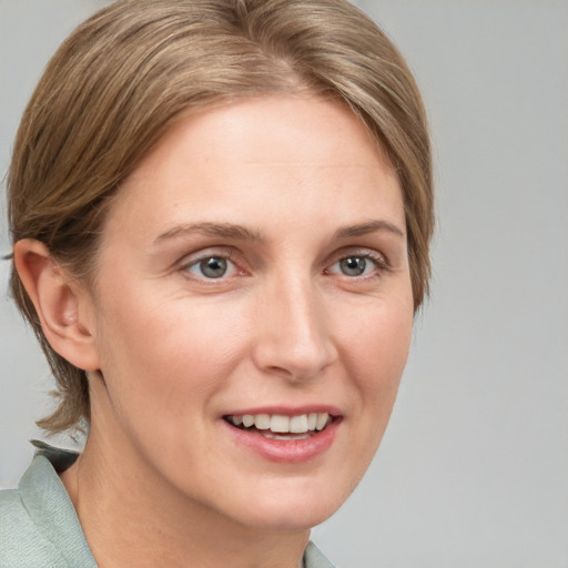 Joyful white young-adult female with medium  brown hair and blue eyes