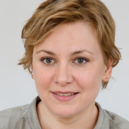 Joyful white young-adult female with medium  brown hair and blue eyes