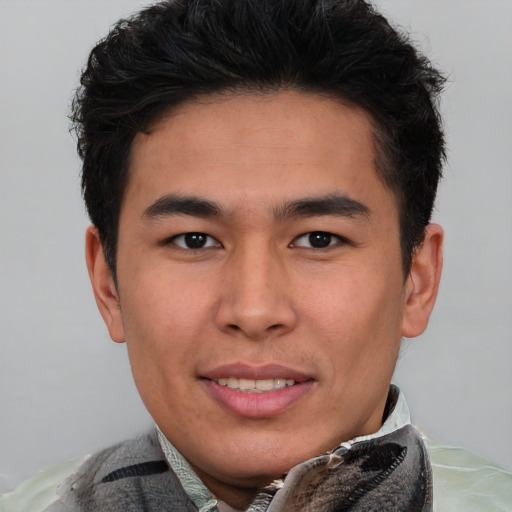 Joyful latino young-adult male with short  brown hair and brown eyes