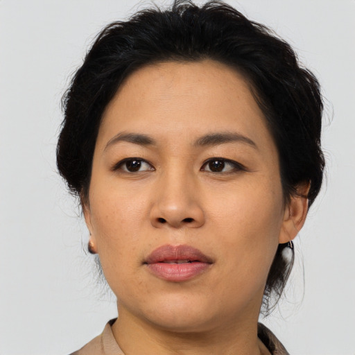 Joyful asian young-adult female with medium  brown hair and brown eyes