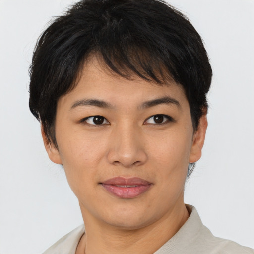 Joyful asian young-adult female with short  brown hair and brown eyes