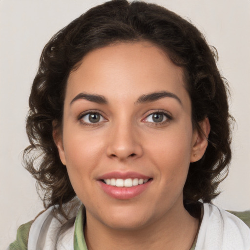 Joyful white young-adult female with medium  brown hair and green eyes