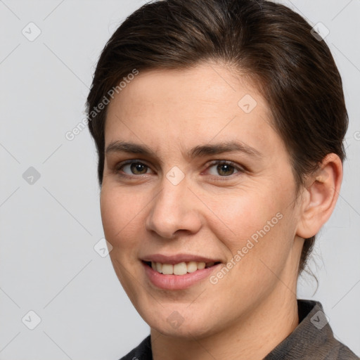 Joyful white young-adult female with short  brown hair and grey eyes