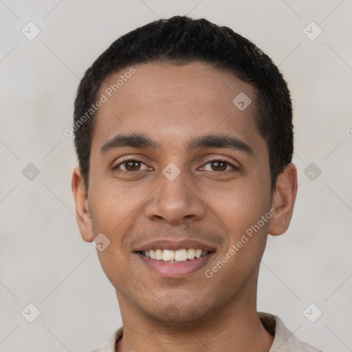 Joyful latino young-adult male with short  black hair and brown eyes