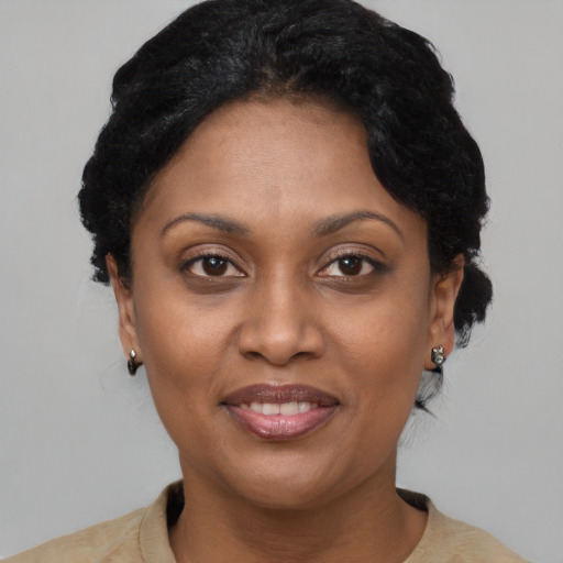 Joyful black adult female with short  brown hair and brown eyes