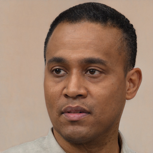 Joyful black young-adult male with short  black hair and brown eyes