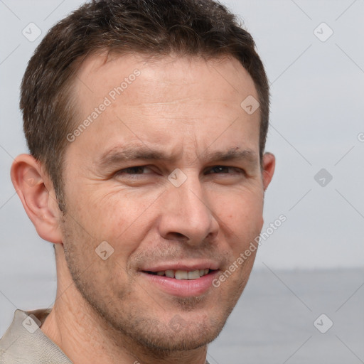 Joyful white adult male with short  brown hair and grey eyes