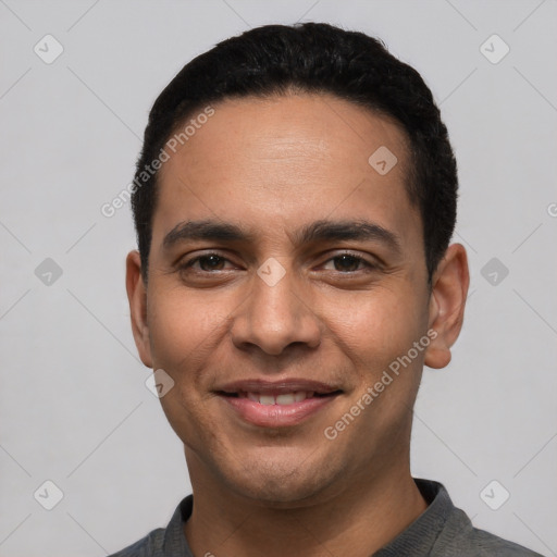 Joyful latino young-adult male with short  black hair and brown eyes