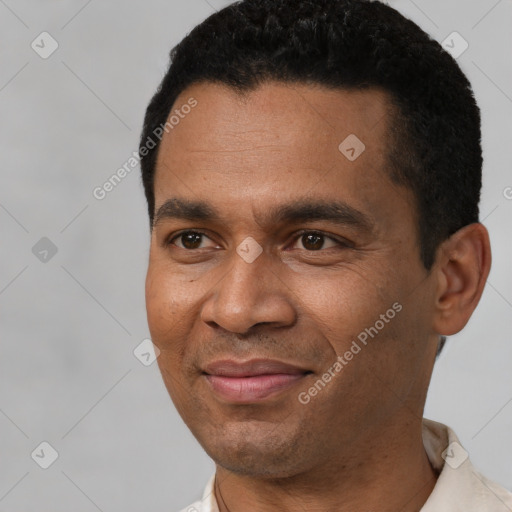 Joyful latino young-adult male with short  black hair and brown eyes