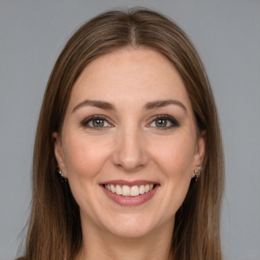 Joyful white young-adult female with long  brown hair and grey eyes