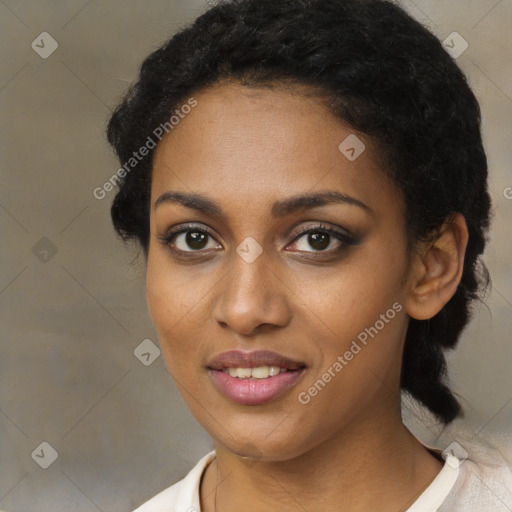 Joyful black young-adult female with short  black hair and brown eyes